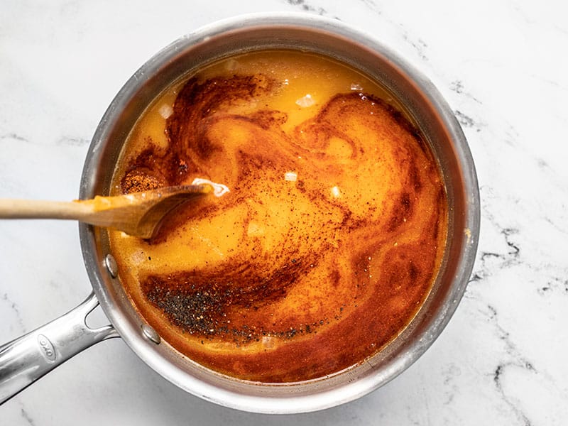 Spices being stirred into the soup.