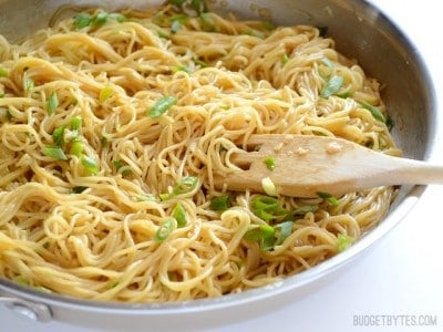 Skillet of garlic noodles garnished with herbs.