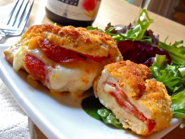 Pepperoni stuffed chicken breast served on a plate.