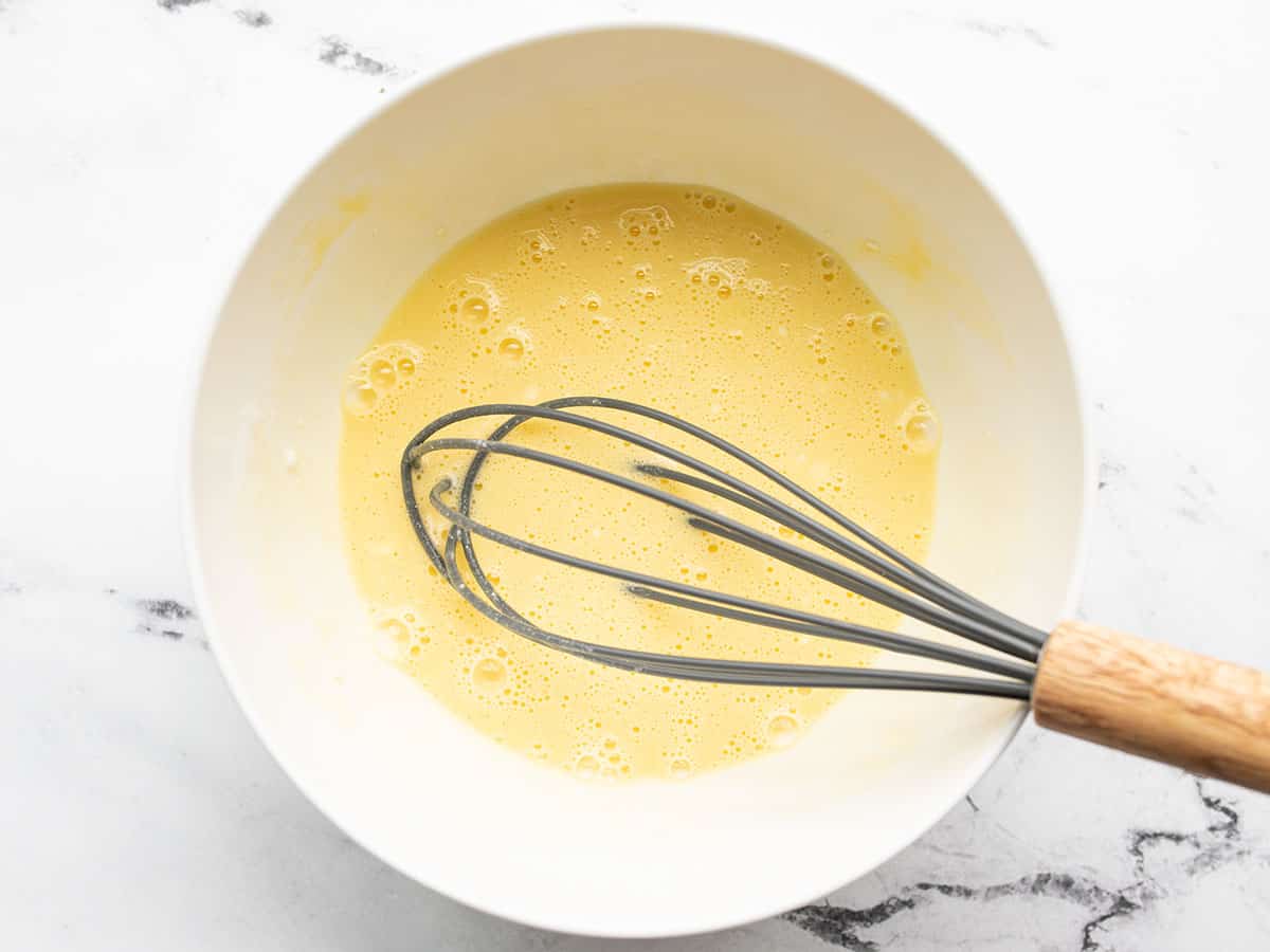 Egg and coconut milk mixed in a bowl