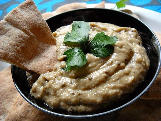 Baba ganoush on a bowl served with pita bread.