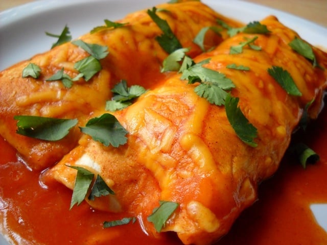 Two sweet potato enchiladas on a plate