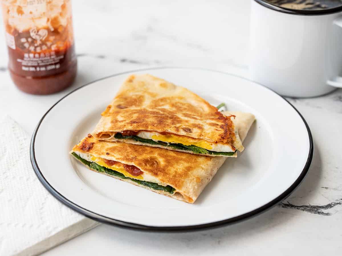 a cut chili garlic breakfast quesadilla on a plate