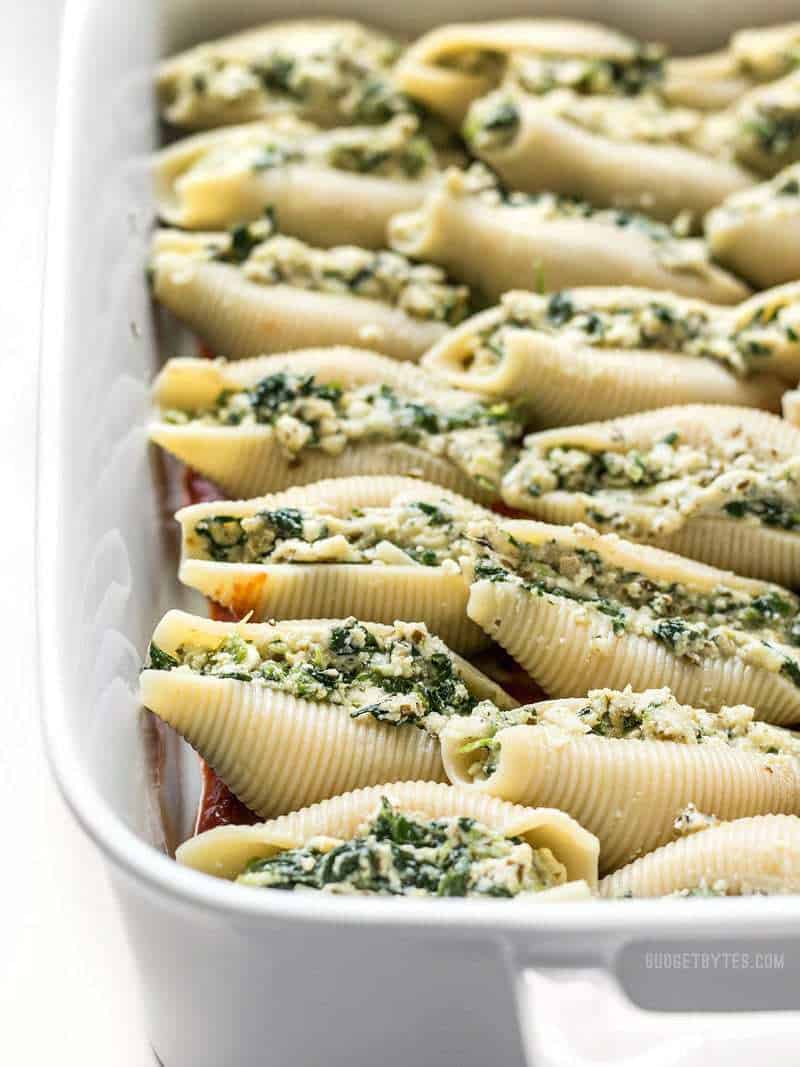 Close up of unbaked Pesto Stuffed Shells without sauce.