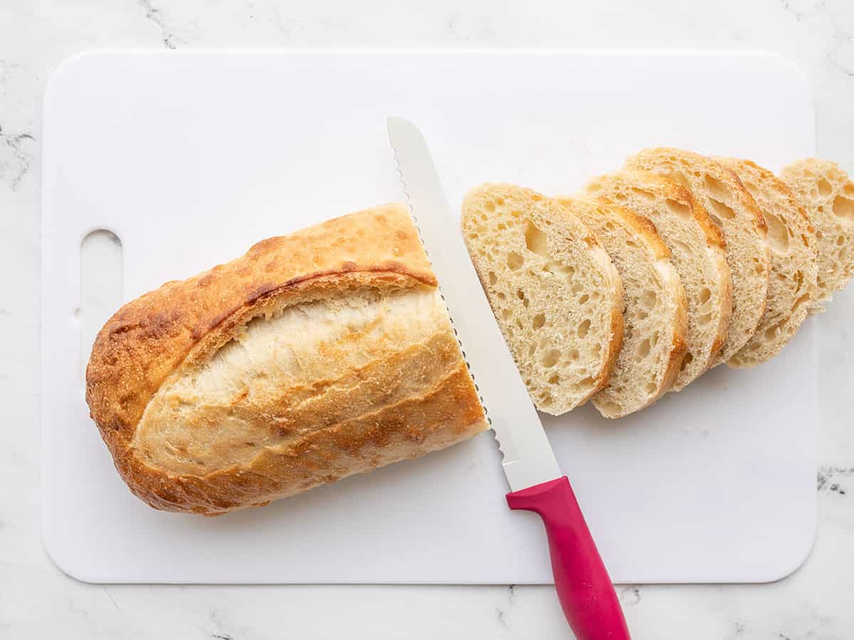 A loaf of bread being sliced