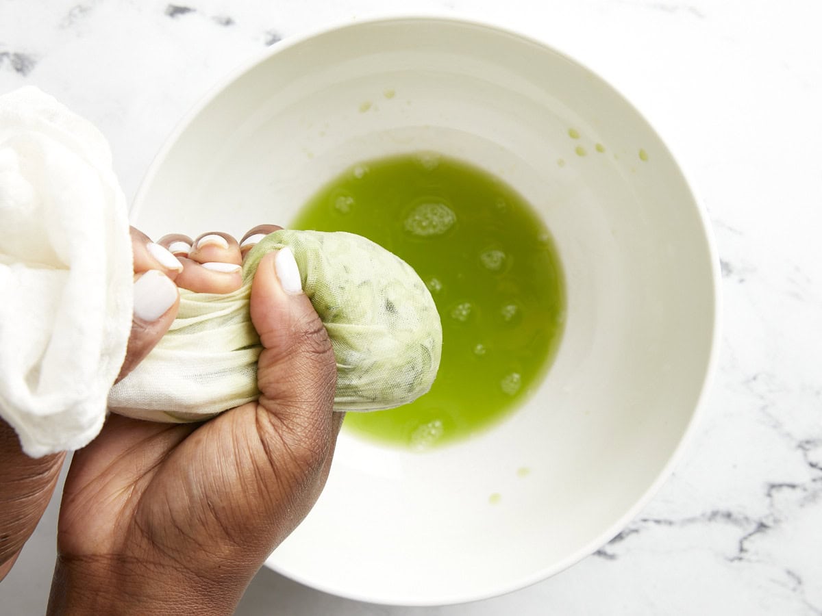 Water being squeezed out of grated cucumber.