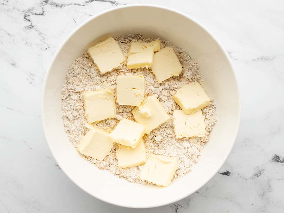 Butter added to the bowl with the dry ingredients