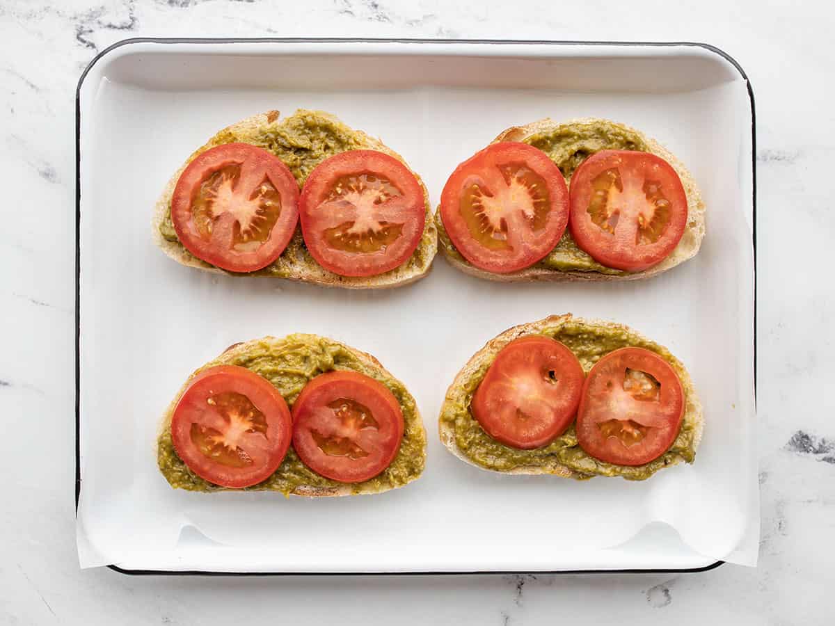 sliced tomatoes on pesto bread