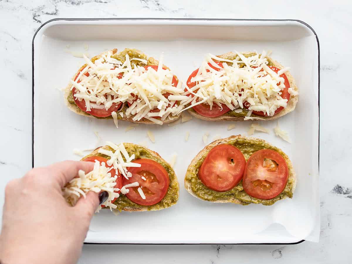 shredded cheese being added to toast