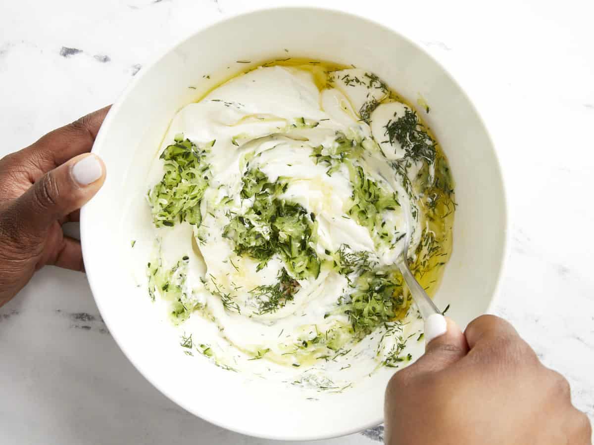 Tzatziki ingredients being mixed together.