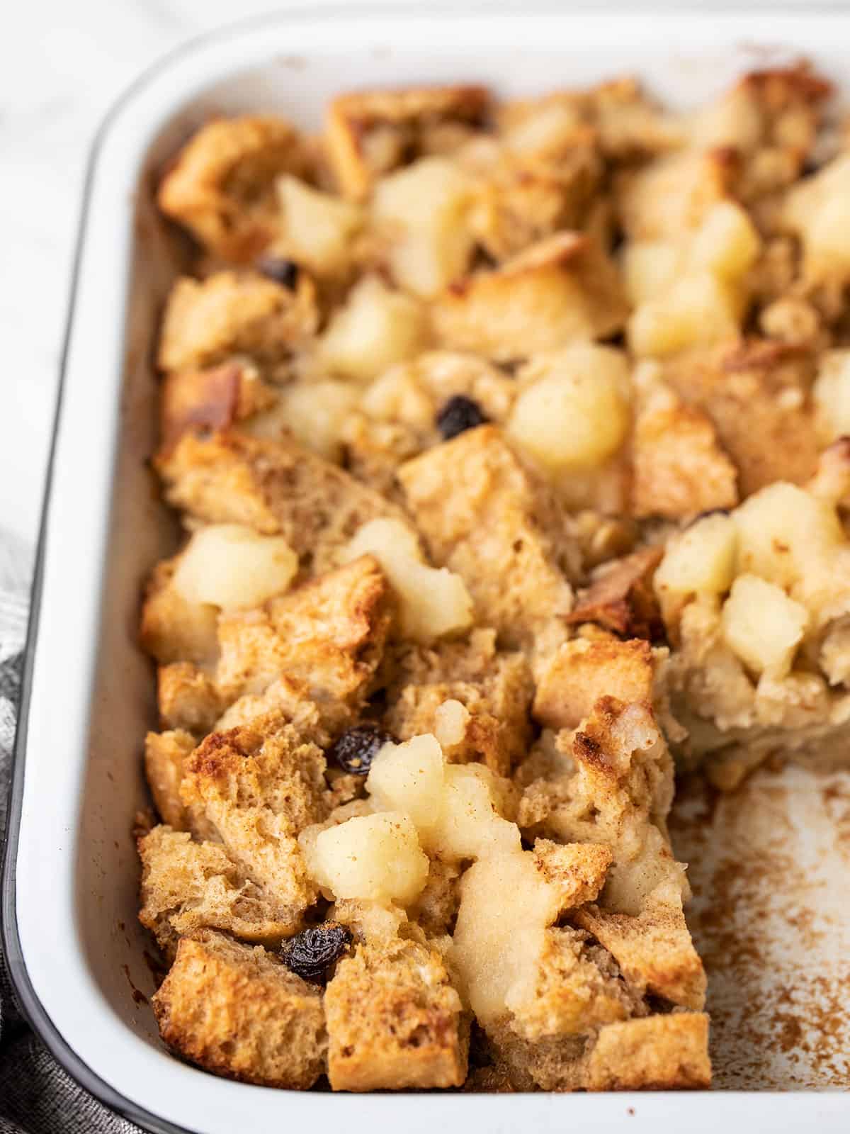 Close up front view of a casserole dish full of apple cinnamon bread pudding