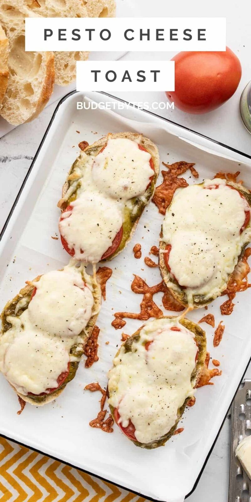 Overhead view of pesto cheese toast on a baking sheet, title text at the top