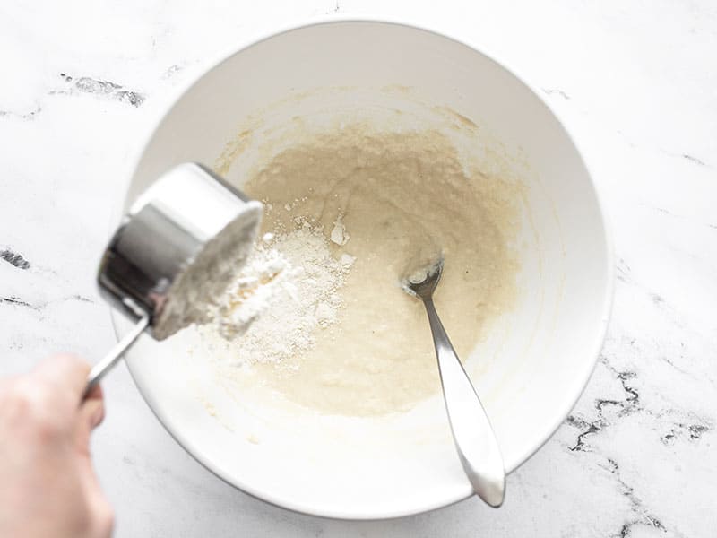 More flour being added to the bowl