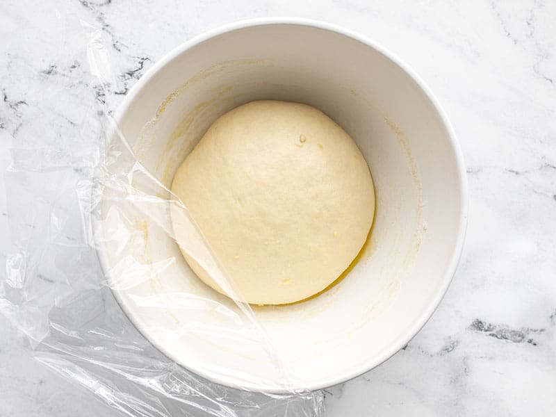 Risen pizza dough in the bowl