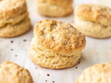 Side view of baked biscuits on a baking sheet