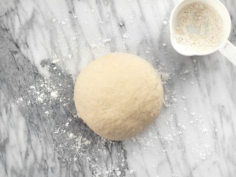 Kneaded Dough on floured marble surface