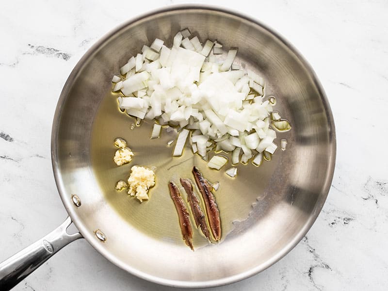 Onions garlic anchovies and oil in a skillet