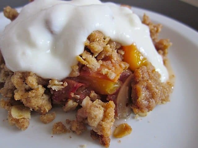 Peach almond crisp topped with vanilla yogurt.