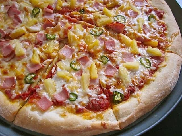 Spicy Hawaiian pizza topped with pineapple and ham.