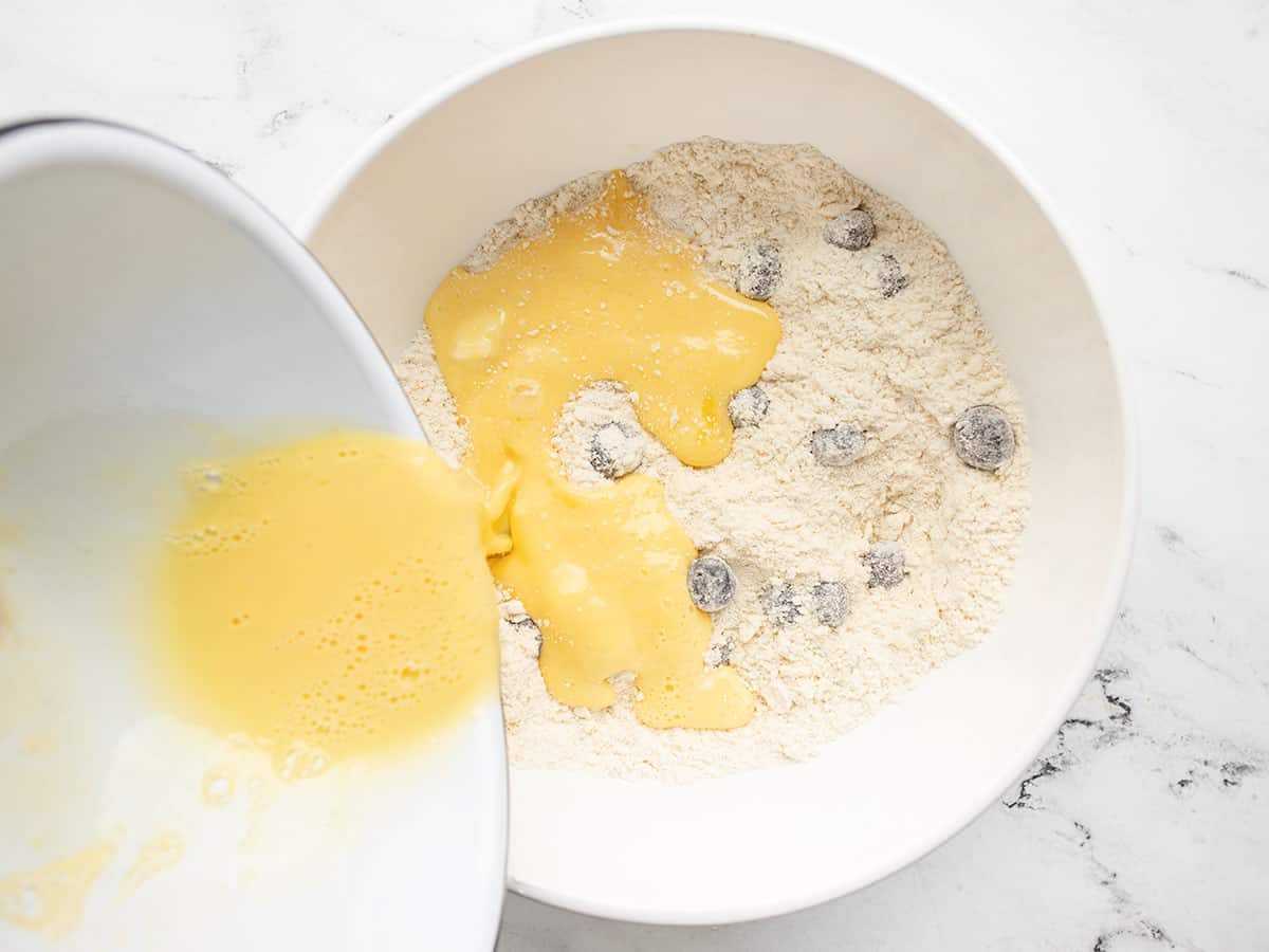 Egg mixture being poured into flour mixture