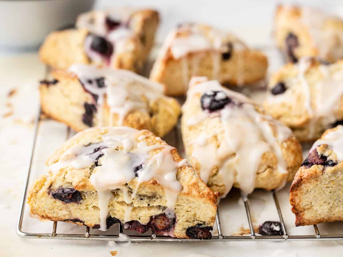 Side view of lemon blueberry scones on a wire cooling rack