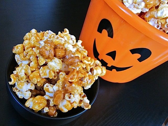 Nutty caramel corn with a festive pumpkin backdrop.