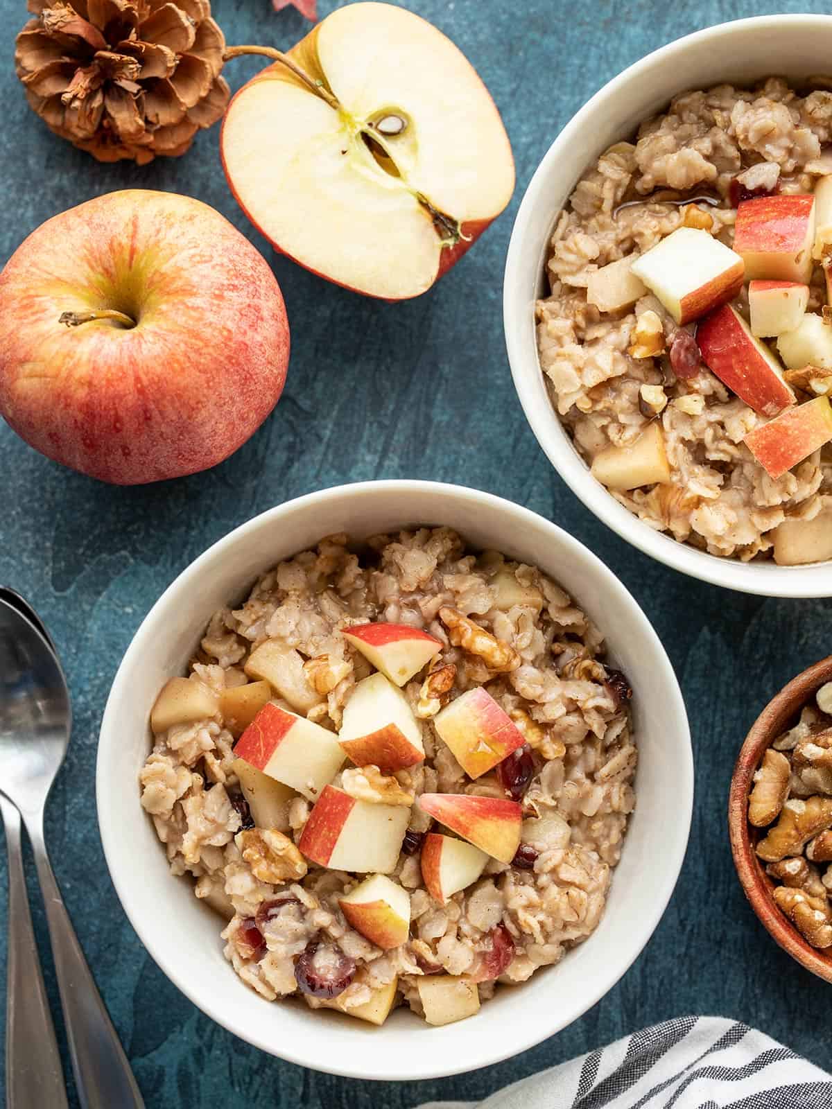 Overhead view of two bowls of autumn fruit and nut oatmeal