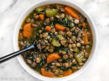 Lentil & Sausage Stew is a fast and easy soup bursting with flavor and chock full of good-for-you vegetables! Plus it freezes well for later. BudgetBytes.com