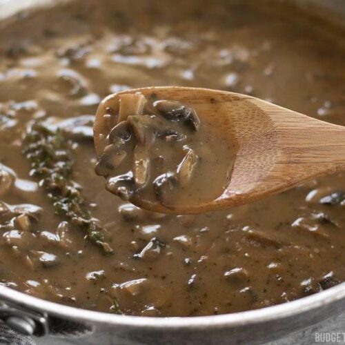 Spoonful of mushroom herb gravy ready to serve.