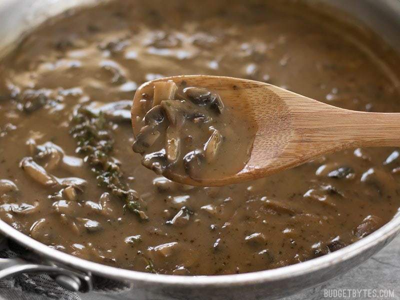 Spoonful of mushroom herb gravy ready to serve.