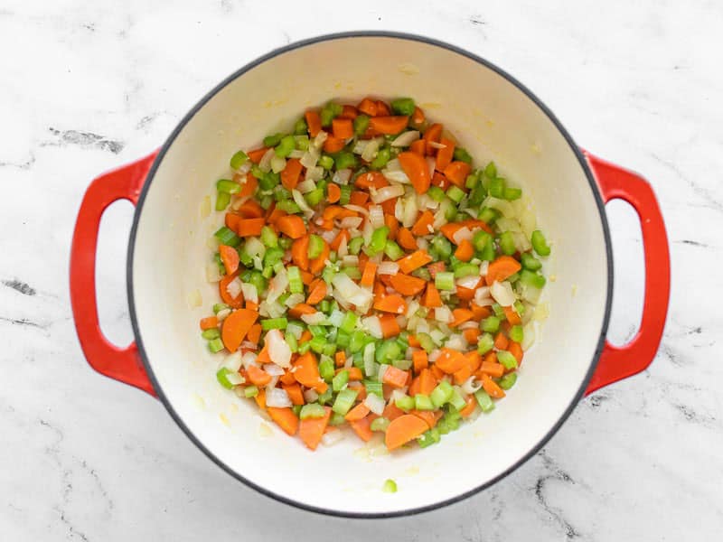 Sautéed vegetables in soup pot