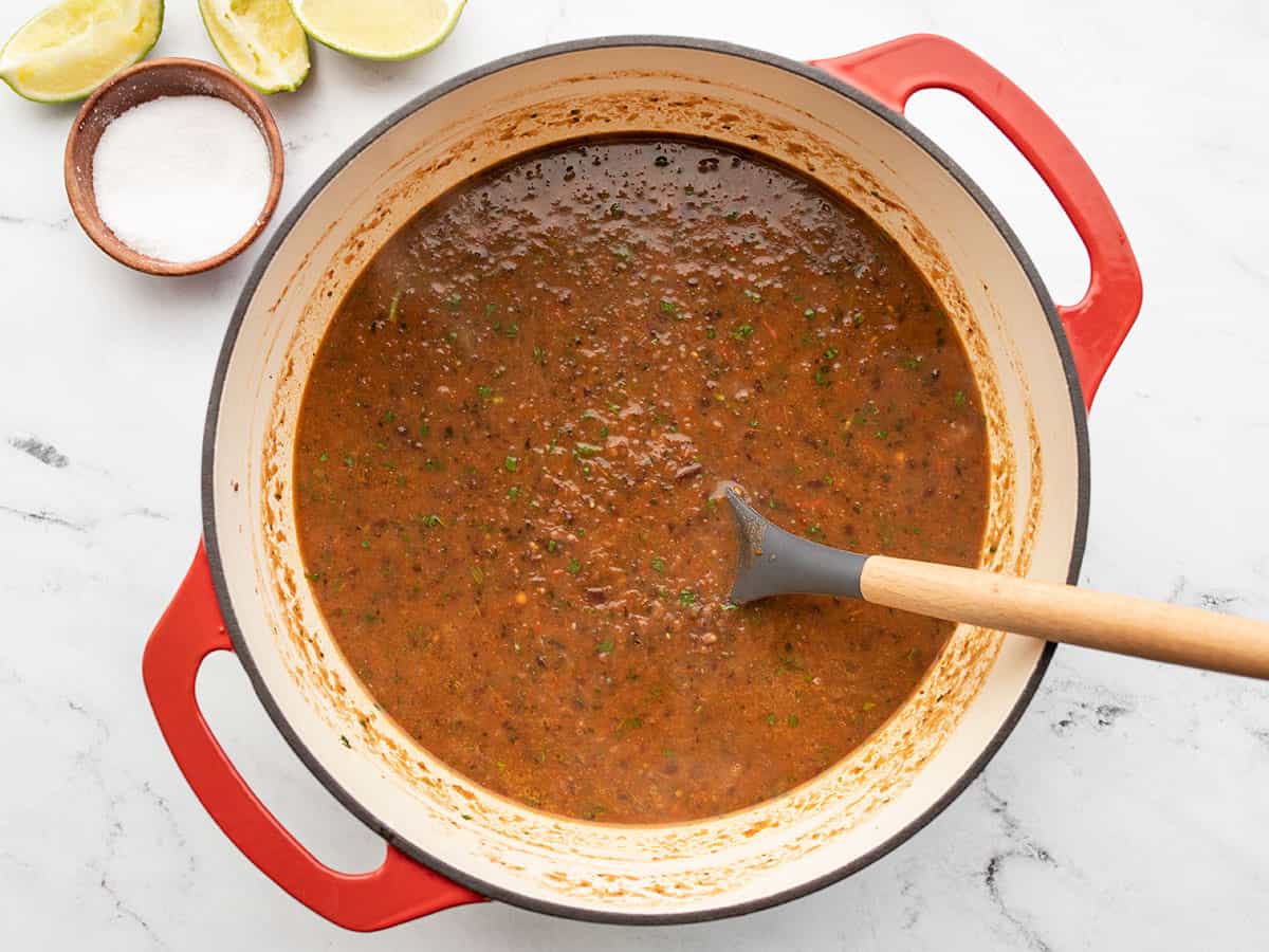 Finished soup in the pot with salt and lime on the side