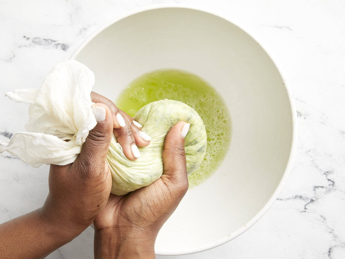 Water being squeezed from zucchini