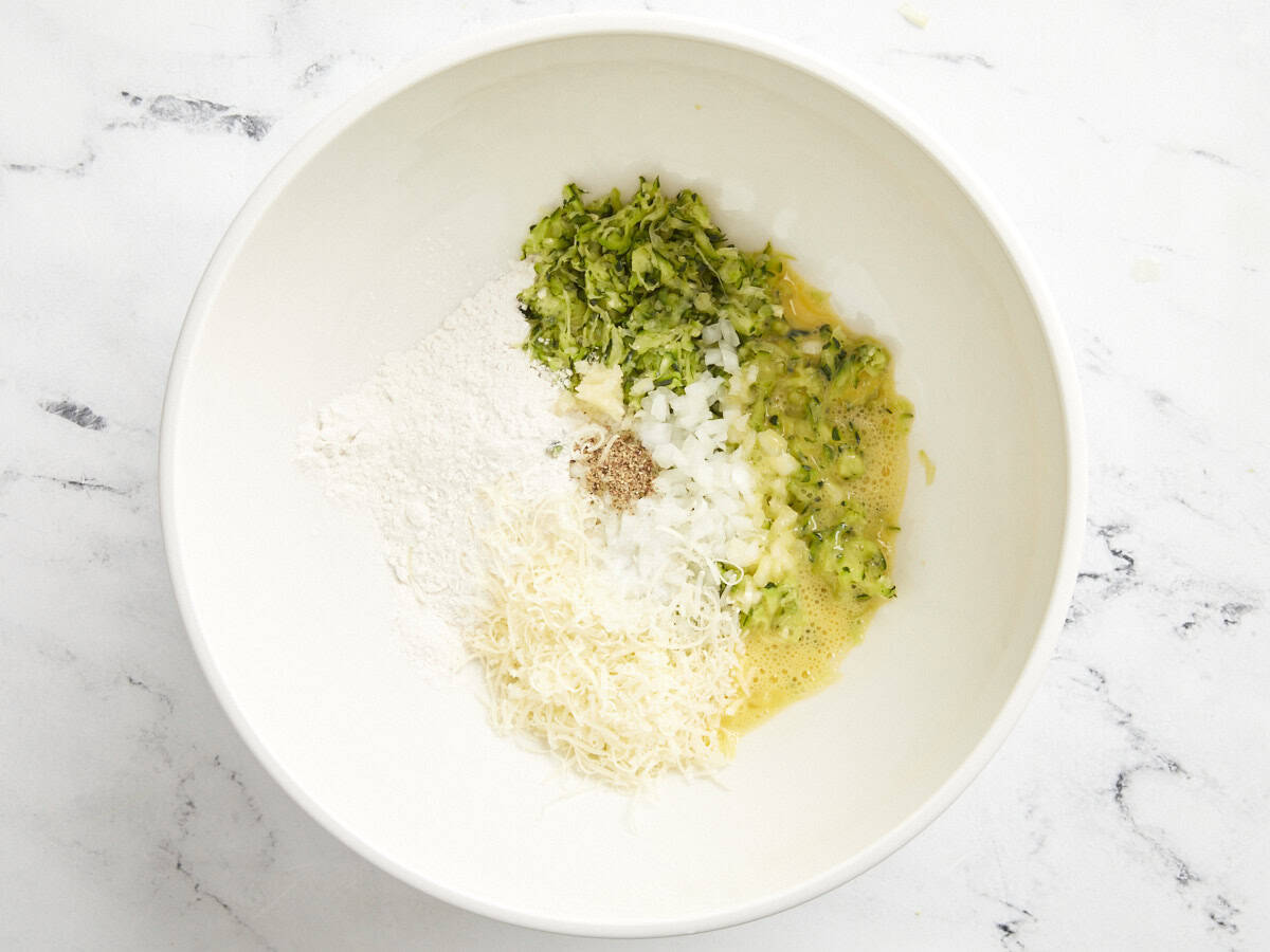 Zucchini fritter ingredients in a bowl.