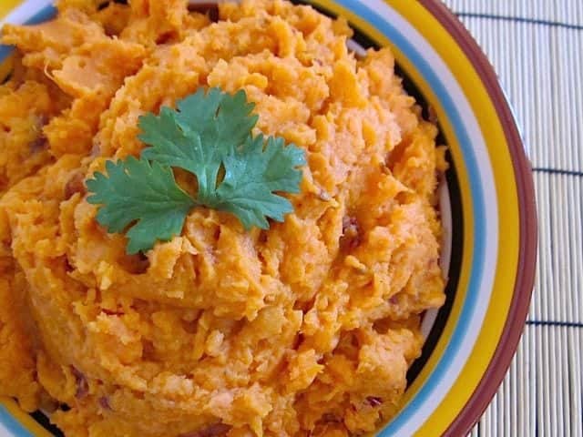 Close-up of chipotle sweet potatoes with herbs.