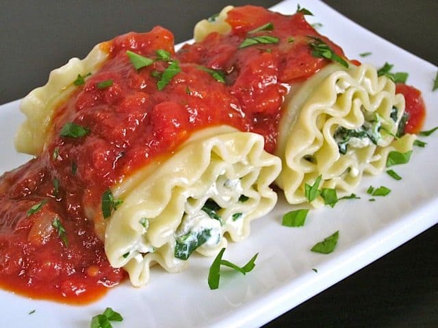 Close-up of spinach roll-ups on a plate.