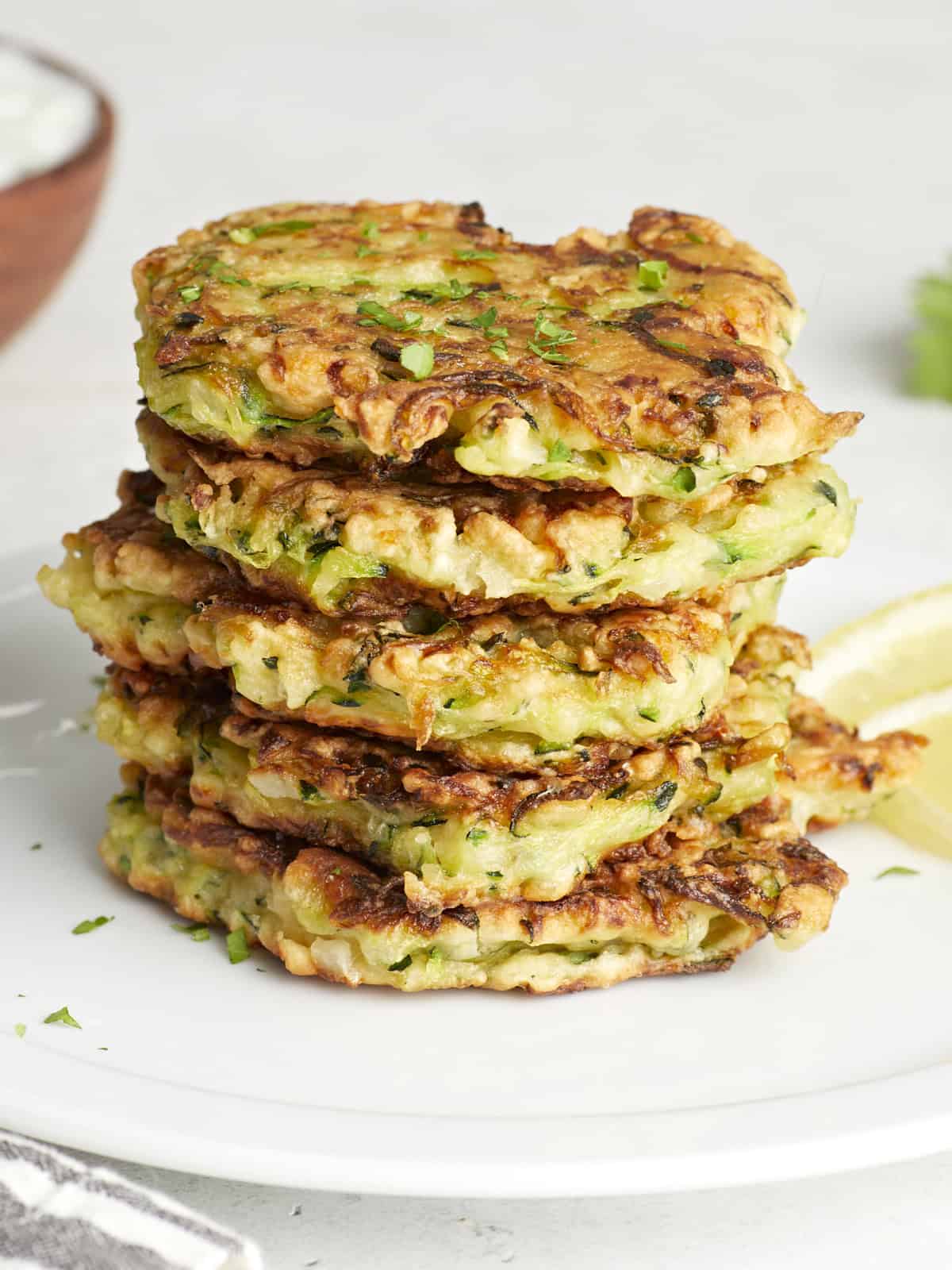 Front side view of a stack of zucchini fritters.