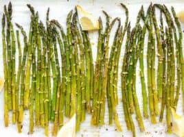 Close up overhead shot of lemon garlic roasted asparagus on the sheet pan