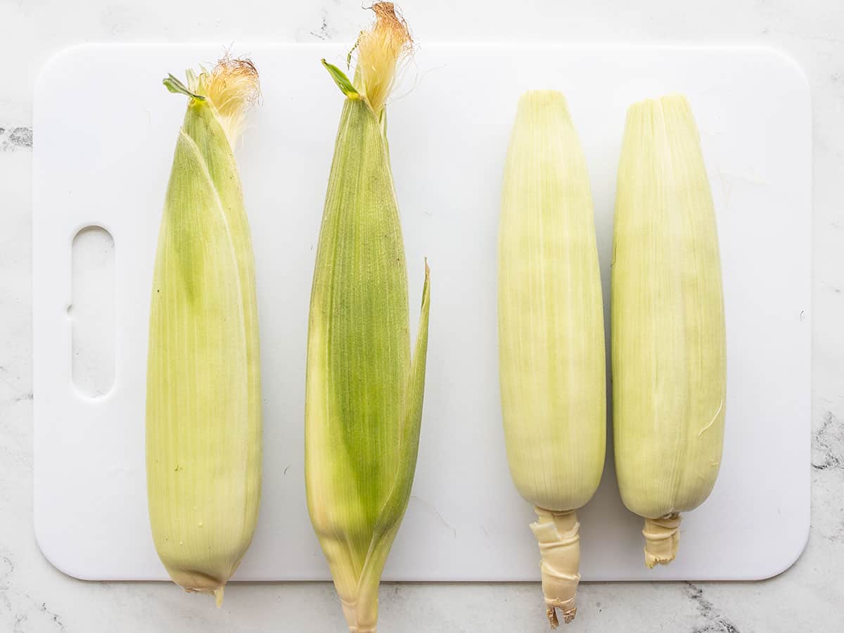 Four fresh ears of corn, two prepped