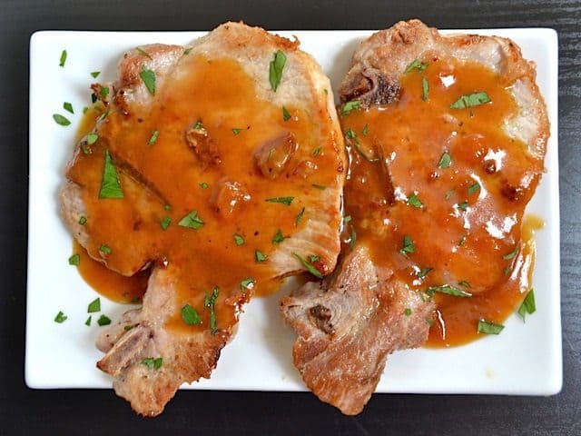 Apricot pork chops displayed on a plate.