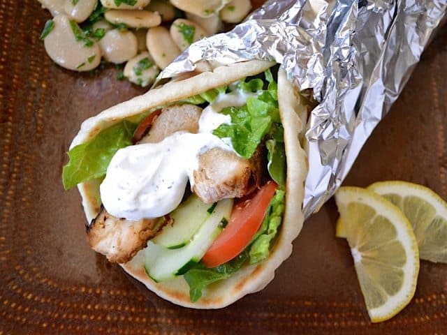 Angle view of chicken shawarma on a wrap.