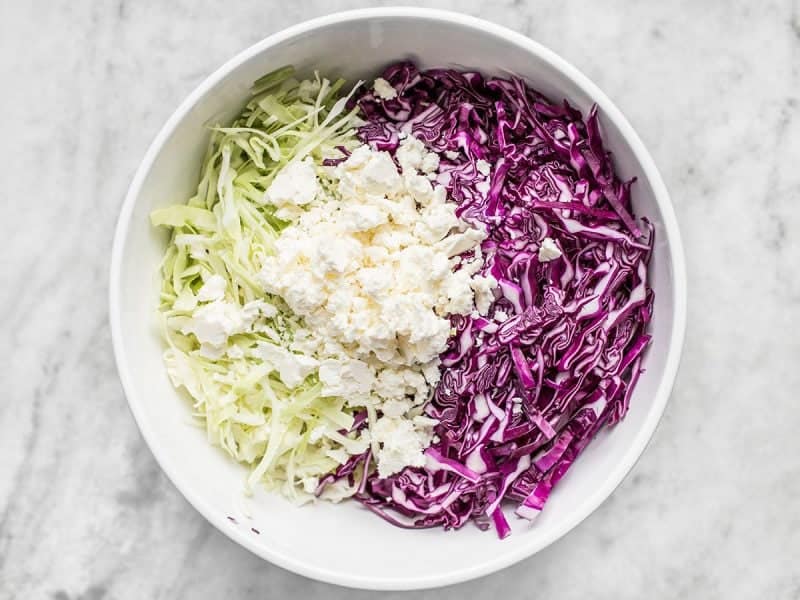 Shredded cabbage and Feta added to bowl 