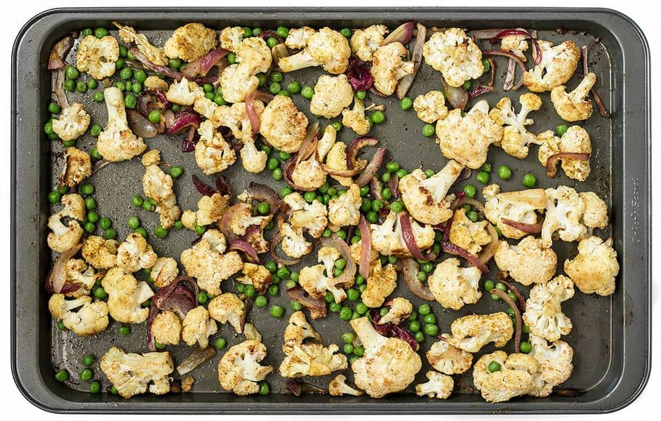 Add peas to roasted cauliflower and onions on sheet pan