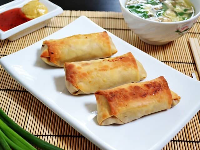 Vegetarian egg rolls served on a plate.