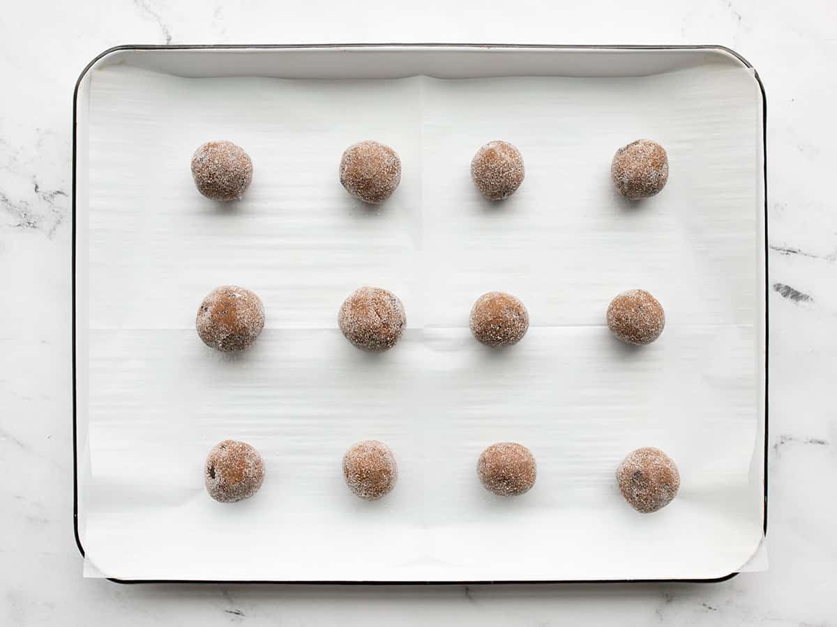 molasses cookies on a baking sheet ready to bake