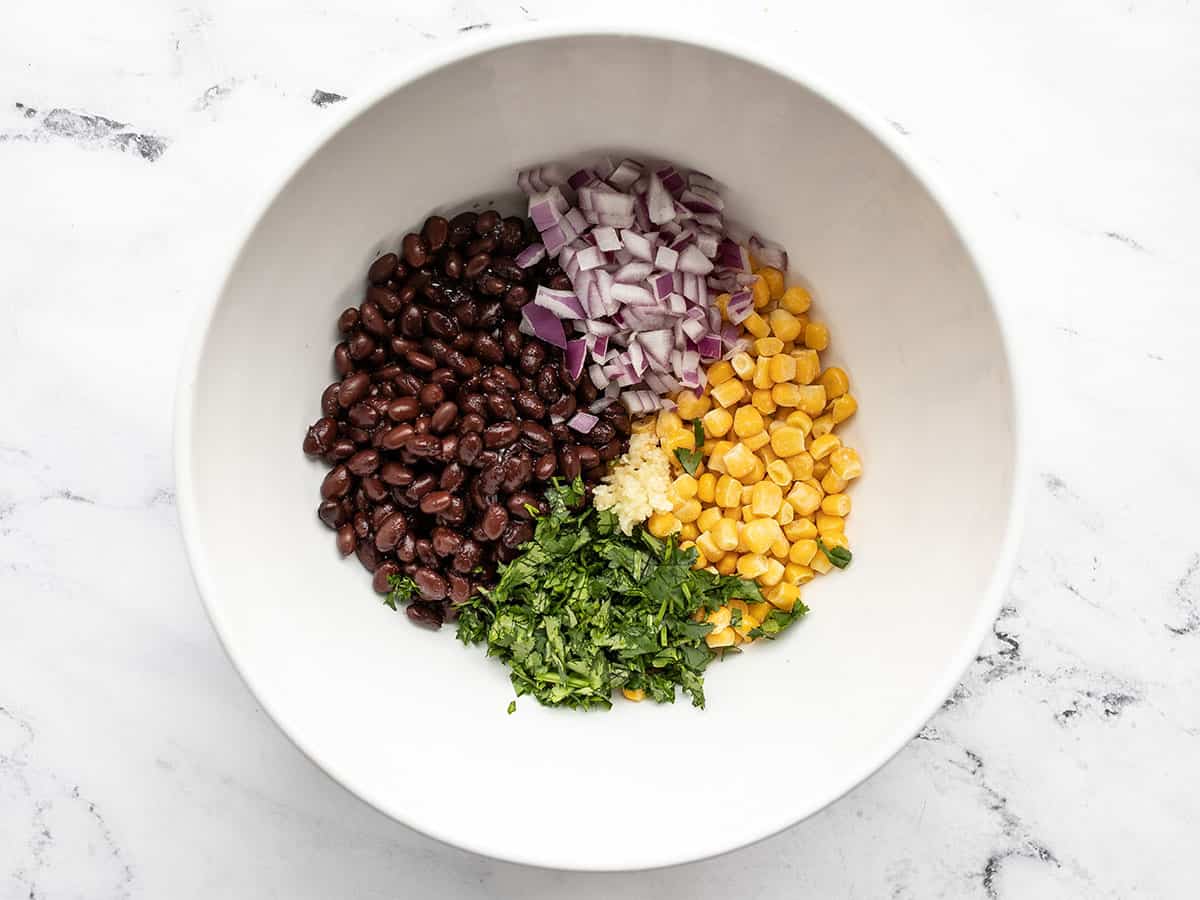 Onion, garlic, and cilantro added to the bowl