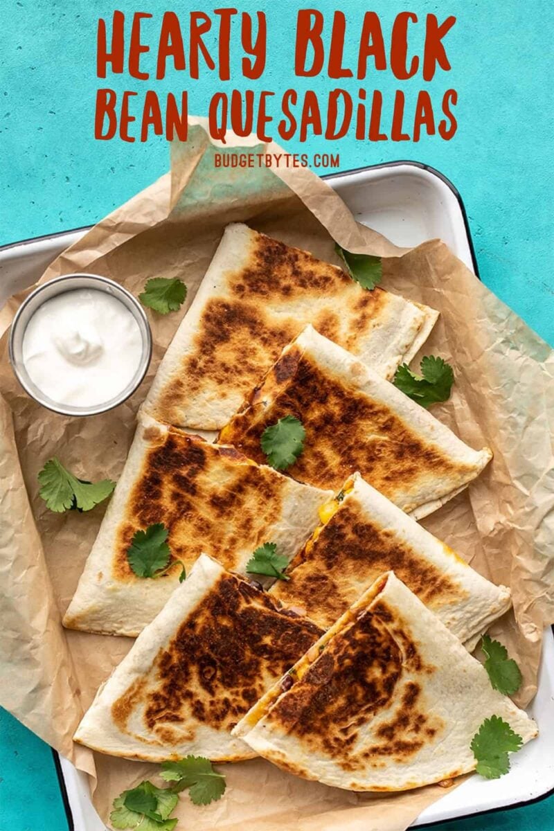 Overhead view of black bean quesadillas on a tray, title text at the top