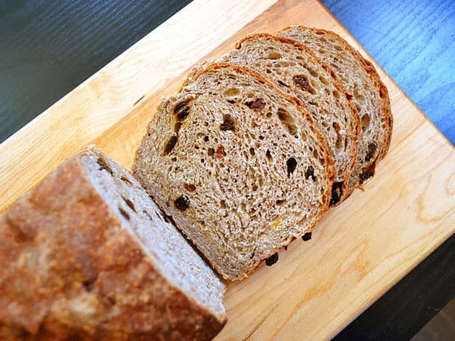 Diagonal slice of spiced bread on a cutting board.