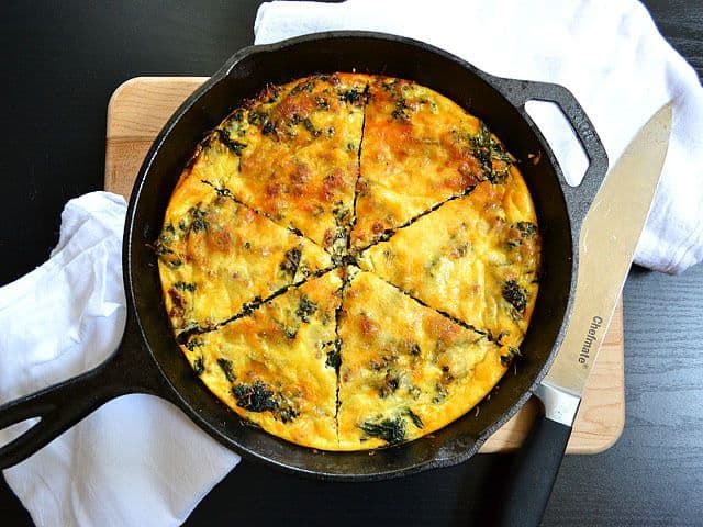 Kale and chorizo strata served on a cast iron pan.