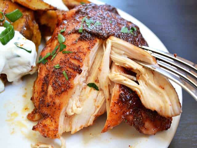 Spicy honey chicken with herbs on a plate.